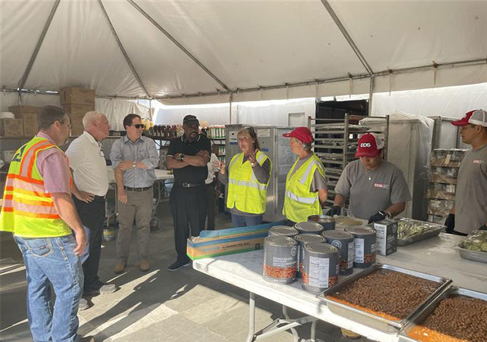 Savannah Mayor Van Johnson and City Manager Jay Melder tour the cafeteria of the Savannah staging site with Region Executive William Mock