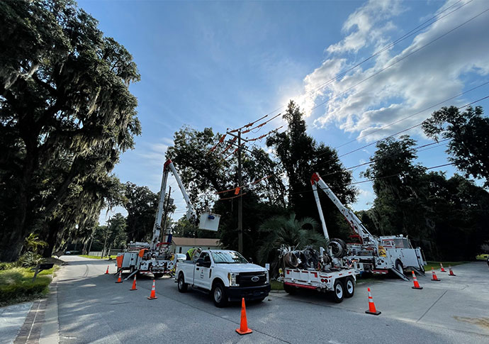 Bucket trucks working in a neighborhood