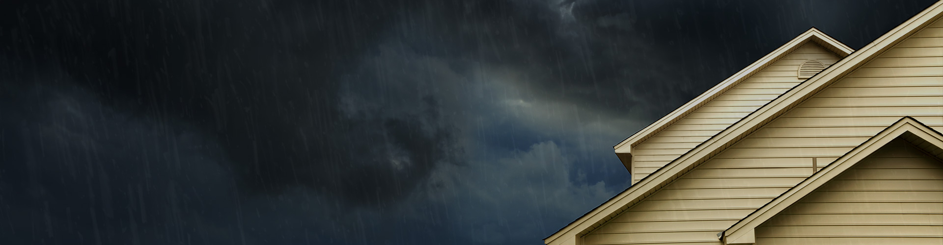 house roof with dark clouds in the background