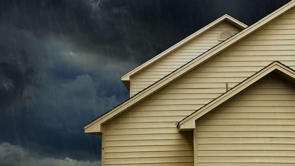 house roof with dark clouds in the background