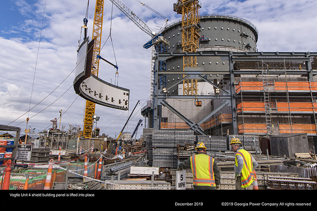 Vogtle Unit 4 shield building panel is lifted into place