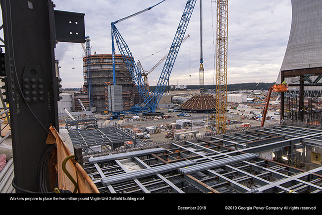 Workers prepare to place the two million pound Vogtle Unit 3 shield buliding roof