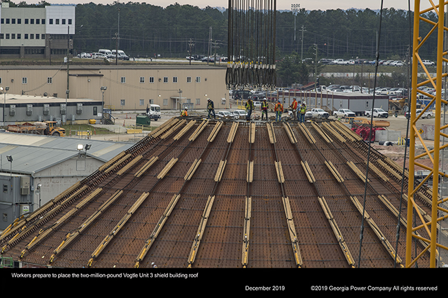 Workers prepare to place the two million pund vogtle unit 3 shield building roof