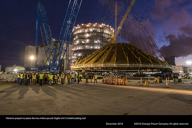 Workers prepare to place the two million pund Vogtle Unit 3 shield building roof