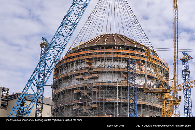 The two million pound shield building roof for Vogtle Unit 3 is lifted into place