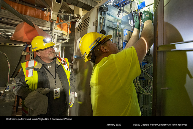 Electricians perform work, inside Vogtle Unit 3 Containment Vessel